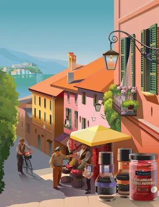 People sitting at a table outside colorful buildings on a sunny street