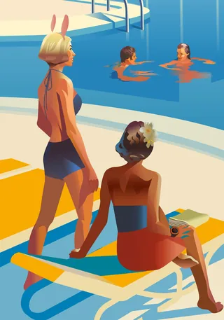 Two women by a pool, one sitting on a lounge chair and the other standing