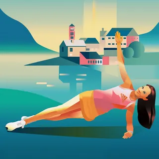 Woman performing side plank workout by lakeside with buildings in background