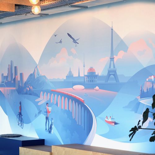 Office mural showing a city skyline, Eiffel Tower, mountains, and people.