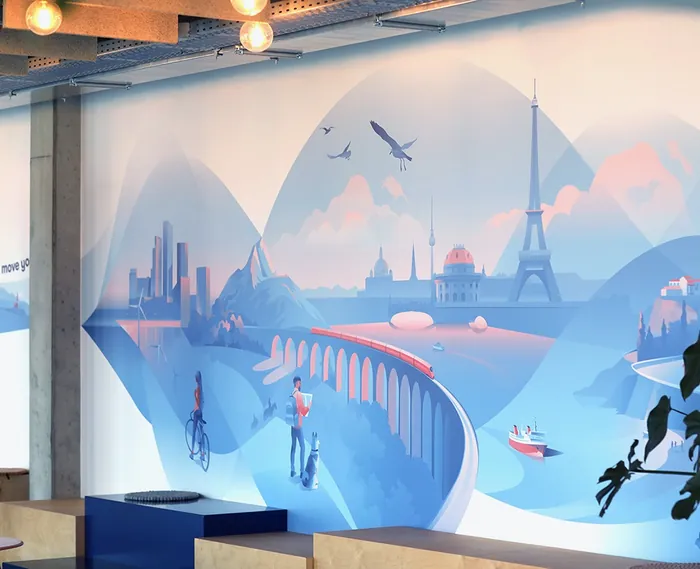 Office mural showing a city skyline, Eiffel Tower, mountains, and people.