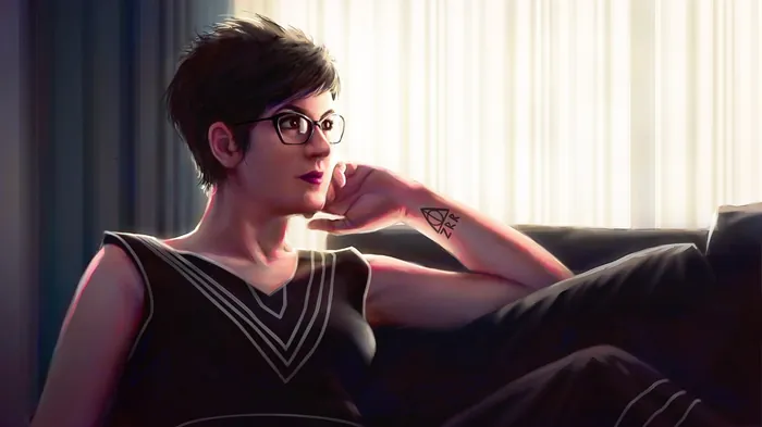 Young woman with short hair and glasses sitting on couch indoors