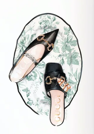 Top view of black Gucci loafers on floral mat by Antonio Soares