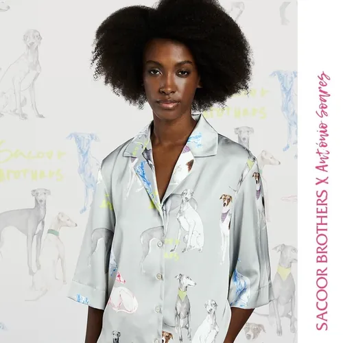 Model in grey shirt with colorful dog illustrations