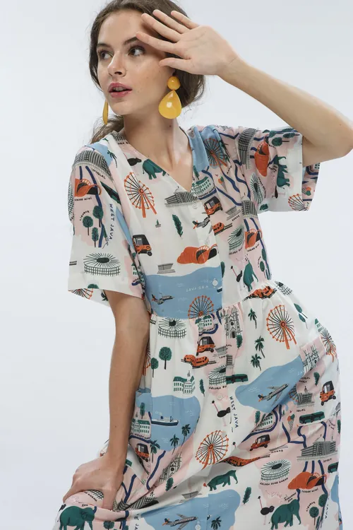 Woman in patterned summer dress with yellow earrings by Ayang Cempaka