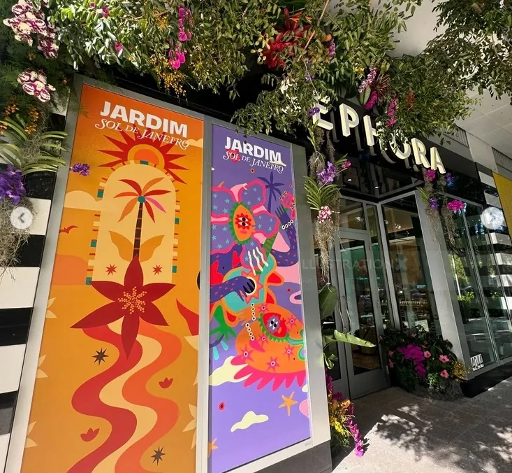 Barbara Tamilin artwork on colorful floral banners outside a garden storefront