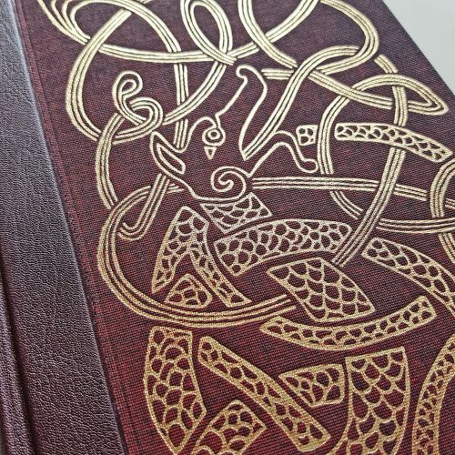 The over of Seamus Heaney's Beowulf for The Folio Society, showing gold foiled linocut illustration 