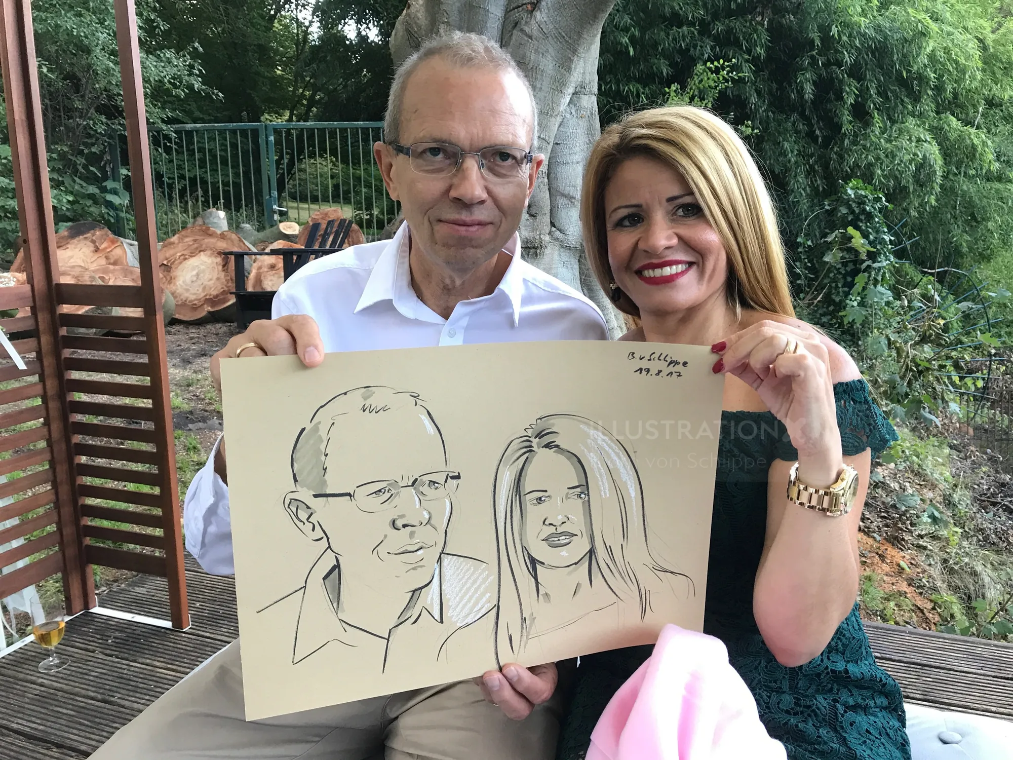Couple holding caricature drawing by Björn von Schlippe