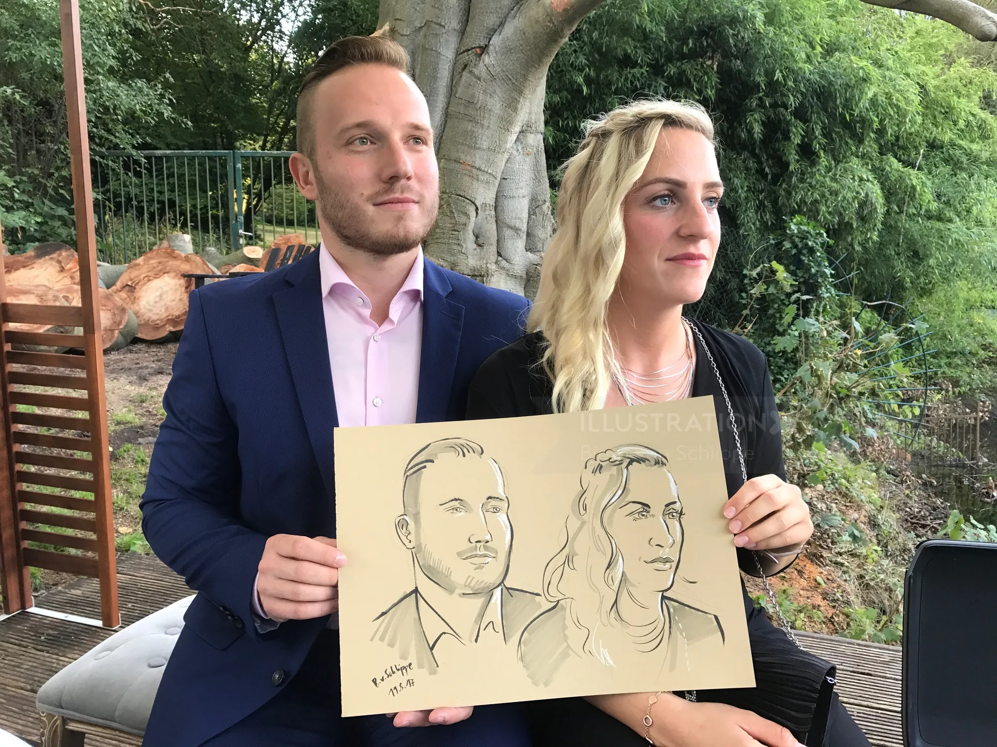 A man and woman hold a portrait drawing by Björn von Schlippe