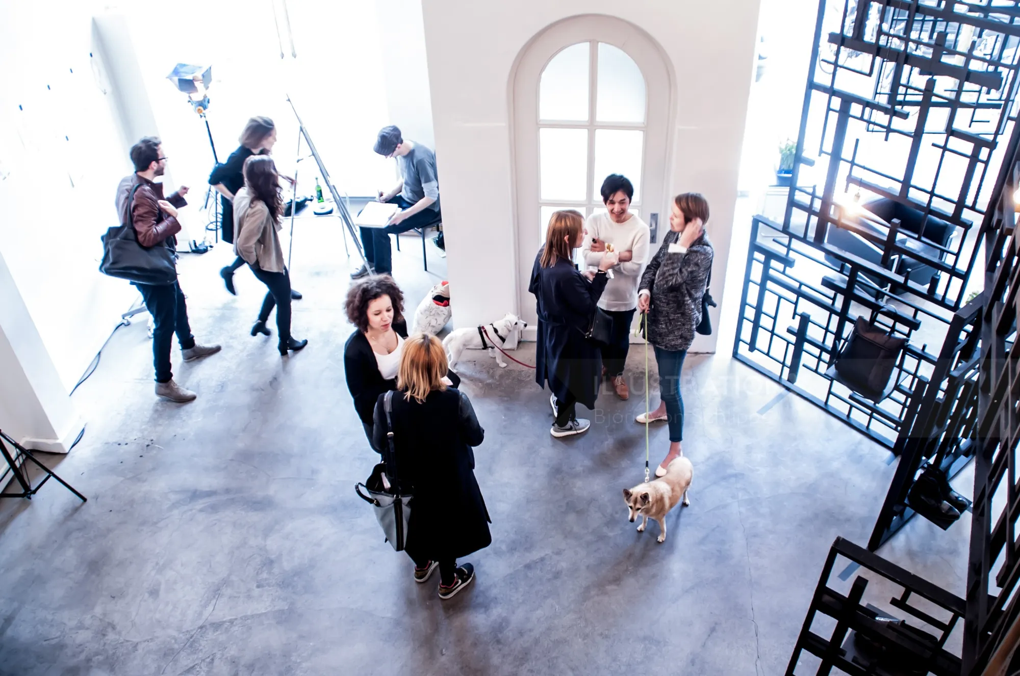 People networking inside a modern art gallery by Björn von Schlippe