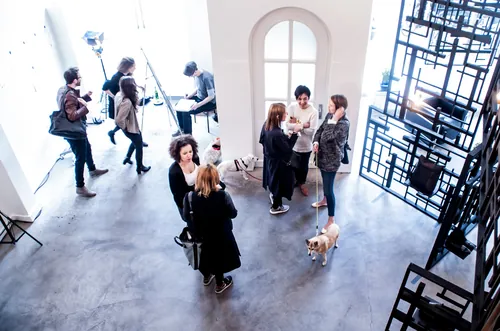 People networking inside a modern art gallery by Björn von Schlippe