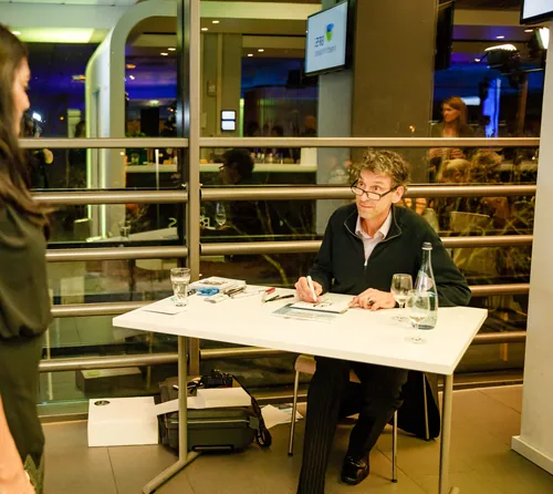 Author Björn von Schlippe signing books at event table