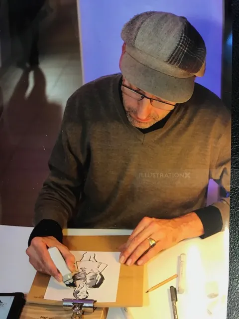 Man in cap and glasses sketching a portrait on paper by Björn von Schlippe