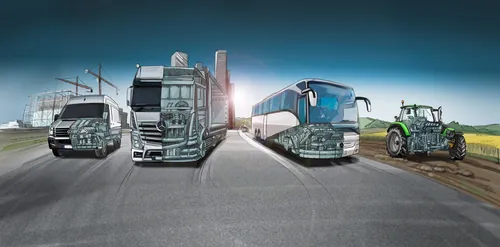 Heavy vehicles including truck, bus, and tractor on road by field by Björn von Schlippe