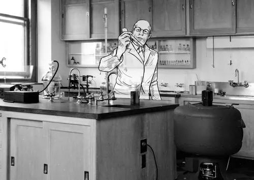 Scientist in white coat holding test tube in laboratory by Björn von Schlippe
