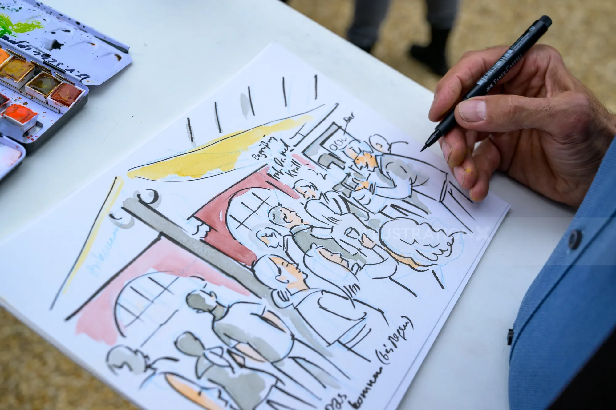 Hand drawing a crowd sketch with watercolor paints
