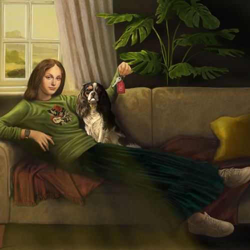 Woman sitting on sofa with dog beside her in a warm lit room