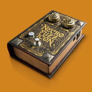 Book-shaped guitar effects pedal by BoomArtwork with brass knobs and ornate design