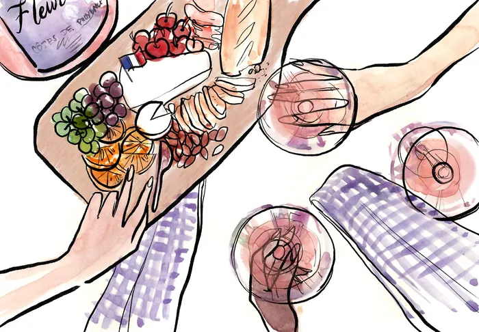 Overhead view of hands reaching for snacks on a wooden board with drinks by Briana Kranz