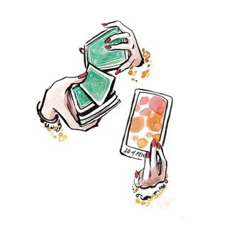 Hands holding and shuffling tarot cards by Briana Kranz