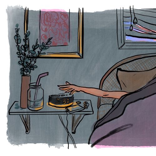 Person reaching for coffee cup on bedside table in morning
