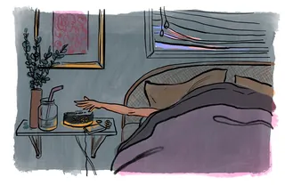 Person reaching for coffee cup on bedside table in morning