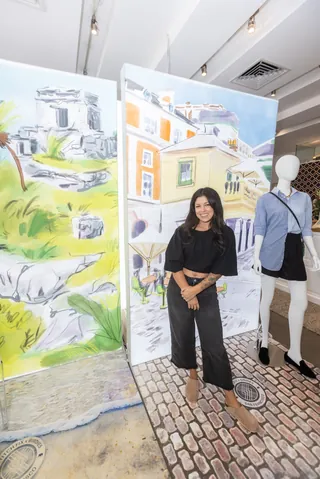 Woman standing next to colorful large-scale artwork and mannequin