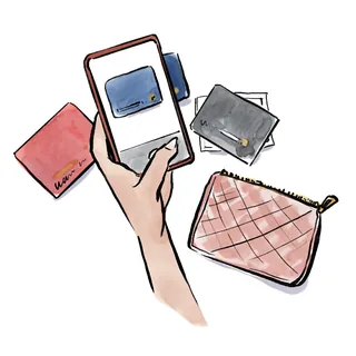 Hand holding wallet cards with credit cards and pink pouch by Briana Kranz