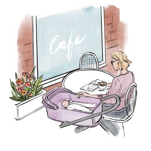 Woman sitting at a cafe table with baby in a bassinet by her side by Briana Kranz