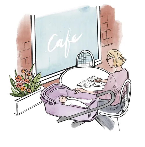 Woman sitting at a cafe table with baby in a bassinet by her side by Briana Kranz