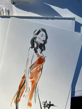 Stylized drawing of a woman in an orange dress by Briana Kranz