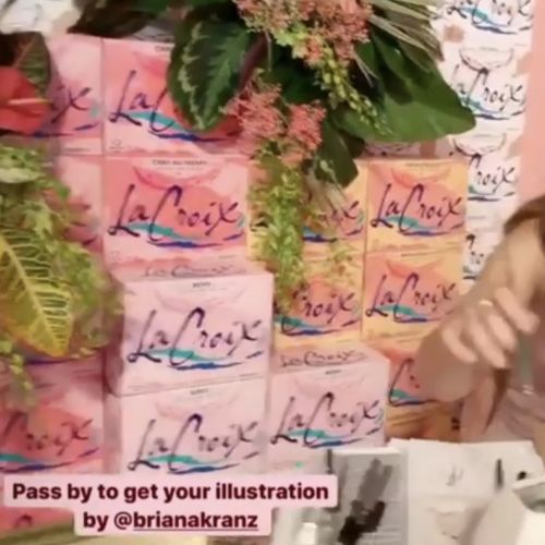 Woman artist drawing at live event with LaCroix cans and plants background by Briana Kranz