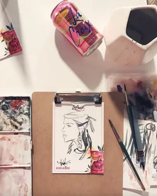 Line drawing of a woman with paintbrushes and drink cans by Briana Kranz