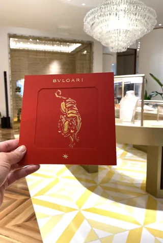 Bulgari red gift box with gold tiger design in a luxury store Briana Kranz