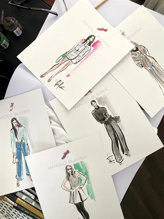 Fashion sketches of models wearing various outfit designs on paper