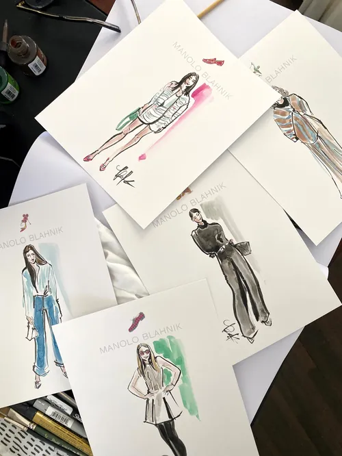 Fashion sketches of models wearing various outfit designs on paper