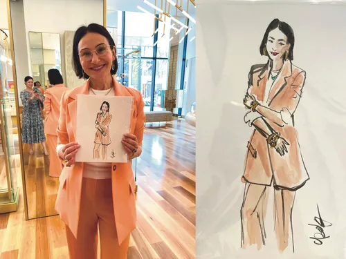 Woman in peach suit holding a fashion sketch at Bulgari event