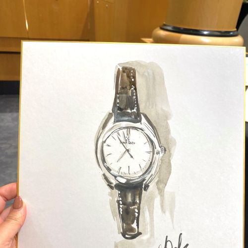 白い紙に手で持ったリアルな手描きの腕時計