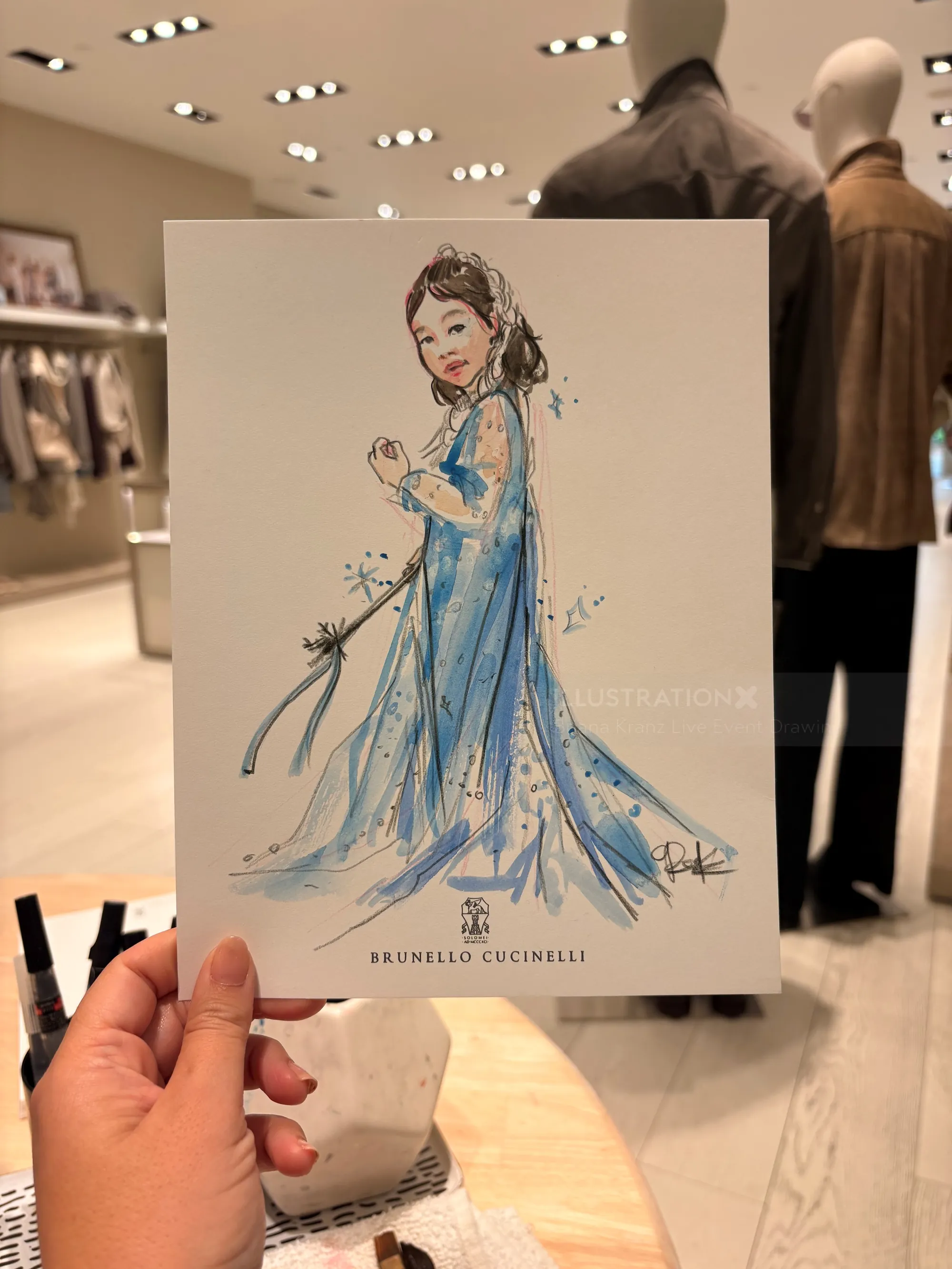 Briana Kranz illustration of a woman in a blue gown at Brunello Cucinelli