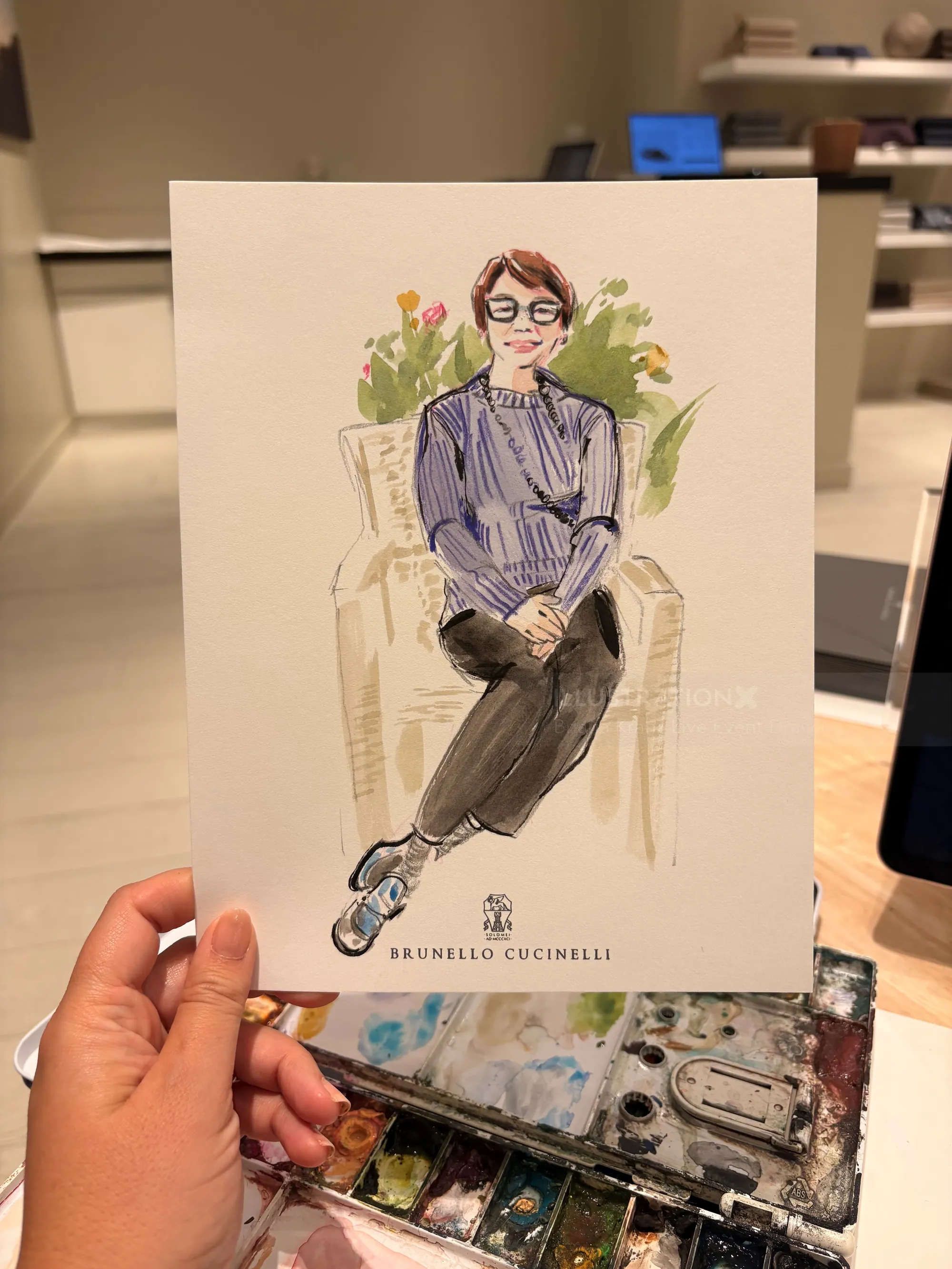 Briana Kranz fashion illustration of a seated woman in a striped blouse