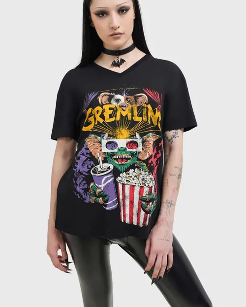 Woman in black Gremlin t-shirt holding popcorn and drink
