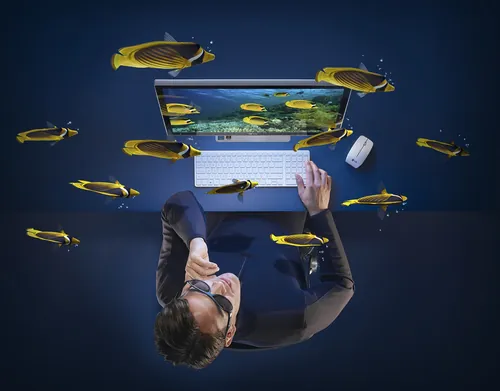 Man working on laptop surrounded by floating fish, artwork by CUBE