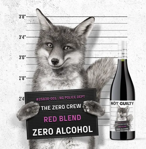 Fox holding mugshot sign with wine bottle labeled Not Guilty by artist CUBE