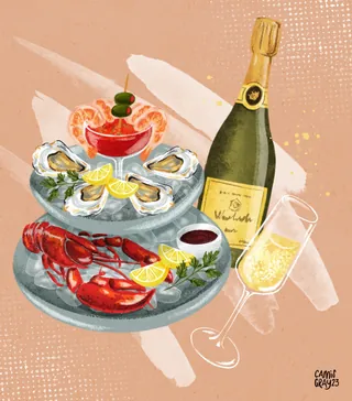 Seafood platter with lobster, oysters, cocktail, and champagne by Camila Gray