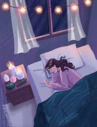 Woman sleeping peacefully in cozy bed with soft candlelight and string lights