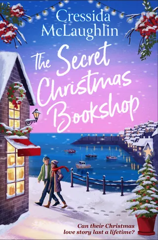 Couple walking in snow near decorated Christmas bookshop by waterfront