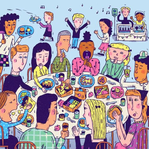 People eating and socializing at a large table with food and drinks