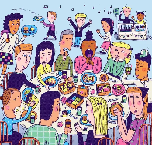People eating and socializing at a large table with food and drinks