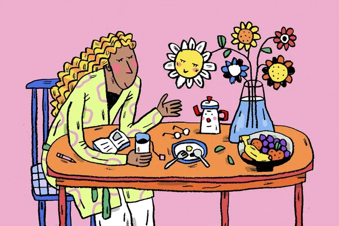 Woman having breakfast at table with flowers and fruit bowl
