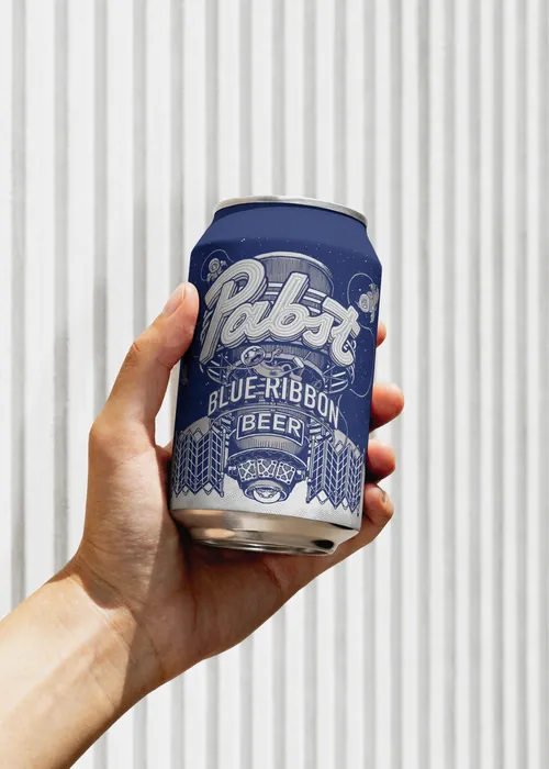 Hand holding a can of Pabst Blue Ribbon beer